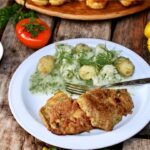 Eskalopki cielęce to kotleciki panierowane cieście z jajka i mąki, a następnie smażone i podane z sosem kalafiorowym z koperkiem.