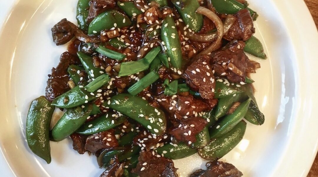 Jagnięcina pokrojona na małe kawałki marynowana w sosie sojowym i oleju sezamowym, a następnie smażona z imbirem, czosnkiem i dymką podawana z groszkiem cukrowym.