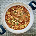 Kotlet schabowy smażony, a potem duszony z cebulą, czosnkiem, ziemniakami i fasolką.