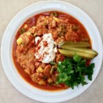 Kotlety schabowe po węgiersku duszone z kiełbaskami debreczynkami, warzywami oraz dużą ilością mielonej słodkiej papryki.