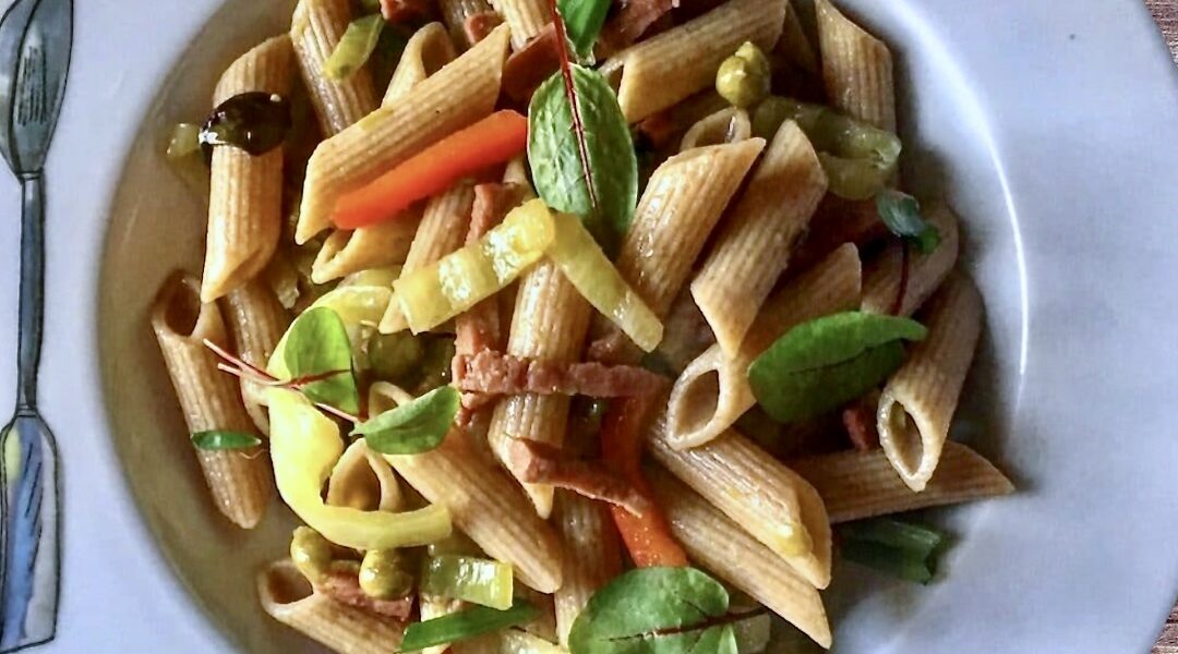 Makaron z pokrojoną w paski mortadelą podany ze smażonymi na oliwie papryką oraz groszkiem.