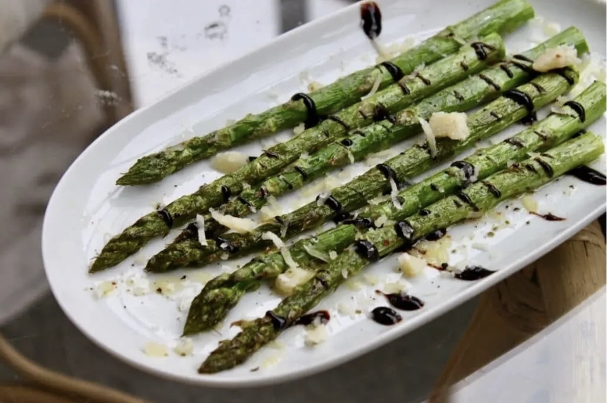 Szparagi zielone skropione oliwą, a następnie krótko pieczone i podane z octem balsamicznym i startym parmezanem.