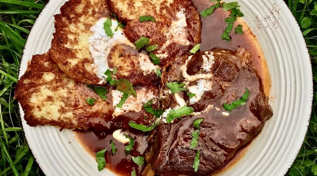 Karkówka wieprzowa pocięta na kotlety i duszona w sosie paprykowym, a następnie podane z chrupiącymi plackami ziemniaczanymi w sosie powstałym podczas duszenia mięsa.