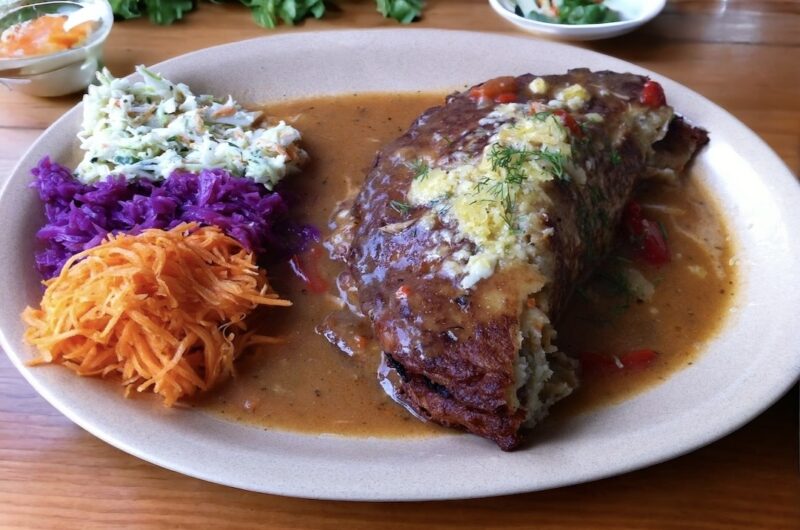 Duży placek ziemniaczany chrupiący z zewnątrz a miękki w środku obłożony gulaszem wieprzowym, a następnie złożony na pół i podany w sosie z gulaszu.