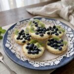 tarteletki z budyniem i owocami na talerzu