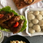 Rolady wieprzowe, czerwona i biała kapusta i kluski, czyli prawdziwy, obfity obiad podany na dużym stole.