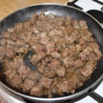 na patelni smażą się małe kawałki wołowiny