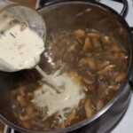 zabielanie śmietaną sosu grzybowego w garnku