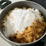 w garnku znajdują się pokrojone pomarańcze z cukrem