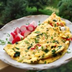 omlet z warzywami na bogato podany na talerzu