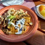 Schab po bakońsku, czyli kotlet schabowy duszony z cebulą, pomidorami, pieczarkami i dużą ilością słodkiej mielonej papryki doprawiony kwaśną śmietaną.