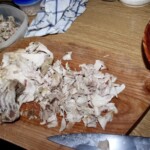 siekanie ugotowanego kurczaka na desce w kuchni