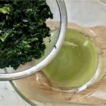 ugotowany szpinak na durszlaku jest odcedzany