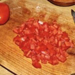 drobno pokrojony pomidor leży na desce kuchennej
