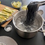 do garnka z gotującą się wodą wrzucany jest makaron barwiony sepią