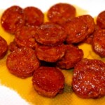 przesmażone plasterki chorizo odciekają na ręczniku papierowym