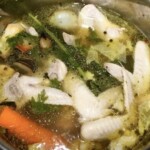 w garnku gotuje się rosół z kurczaka z warzywami