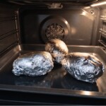 ziemniaki w folii aluminiowej pieką się w piekarniku