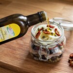 śledź w oleju z kaparami i oliwkami w trakcie przygotowania