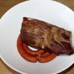 w dużej misce leży ugotowane żeberko wędzone oraz kiełbaski