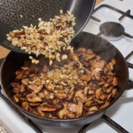 krojone świeże grzyby leśne smażą się na patelni z cebulką krojoną w drobną kostkę