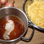 starte na placki surowe ziemniaki, a obok w garnku skrobia z odciekniętych startych ziemniaków