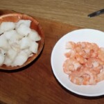 obrane krewetki i pokrojone w kawałki mięso dorsza