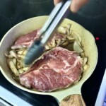 na patelni smażą się dwa kotlety z karczku z cebulą