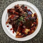 gęsina pieczona podana na kluskach śląskich smażonych z sosem pieczeniowym