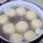 w dużym garnku gotują się knedle z morelami