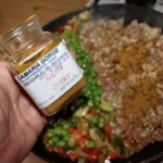 słoiczek z przyprawą curry w dłoni