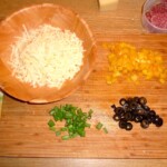 starty ser w misce oraz posiekane czarne oliwki