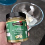 słoiczek z pastą pistacjową w dłoni